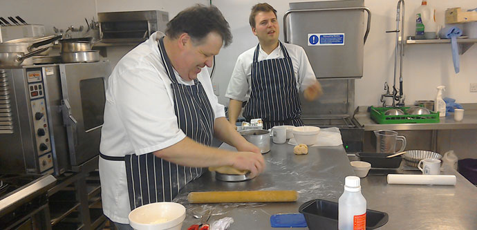 Learning cookery skills at Larmer Tree Gardens